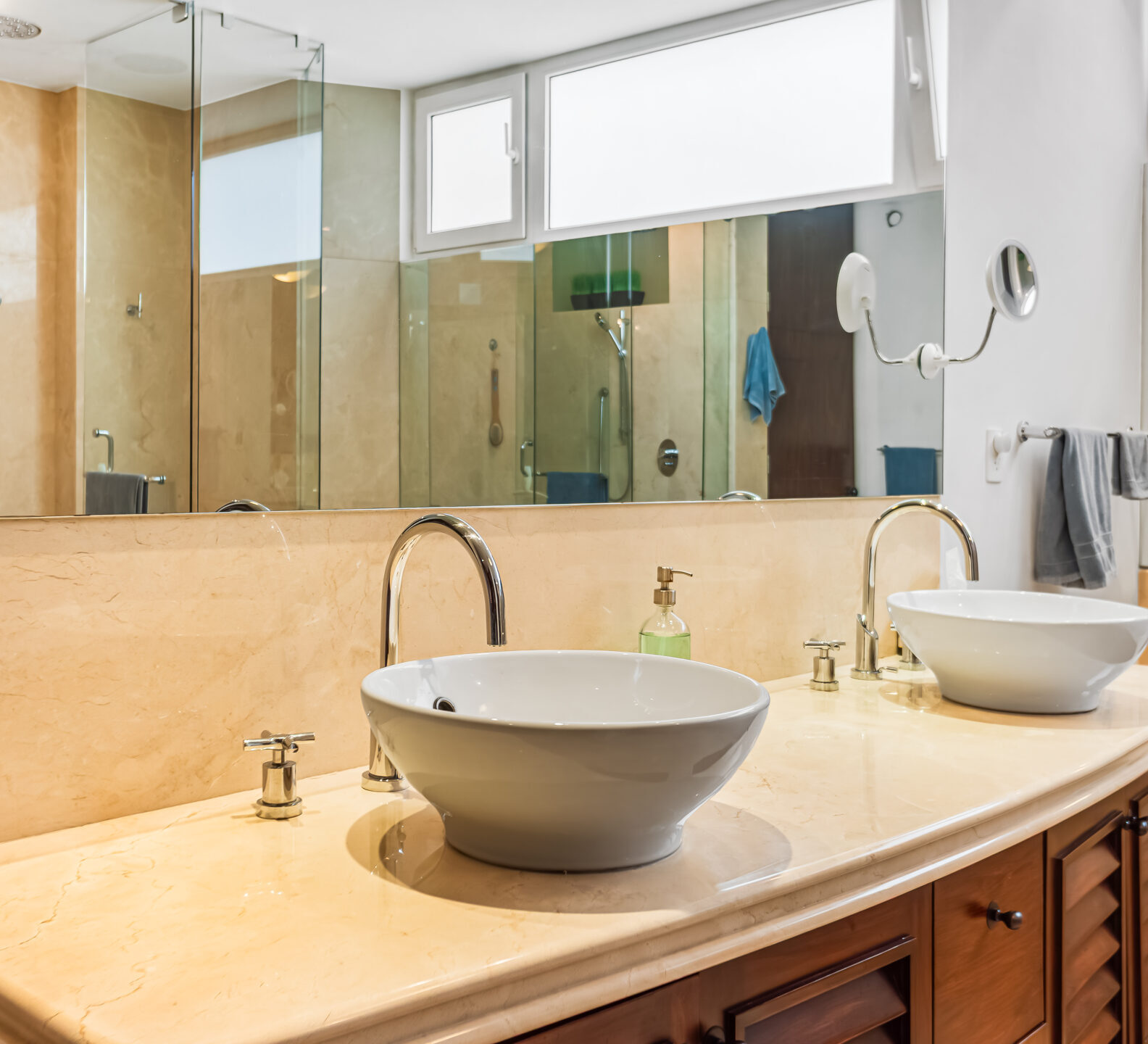 SDM Arco Major 4-23 Bathroom with dual vessel sinks, wood cabinetry, and a large mirror.