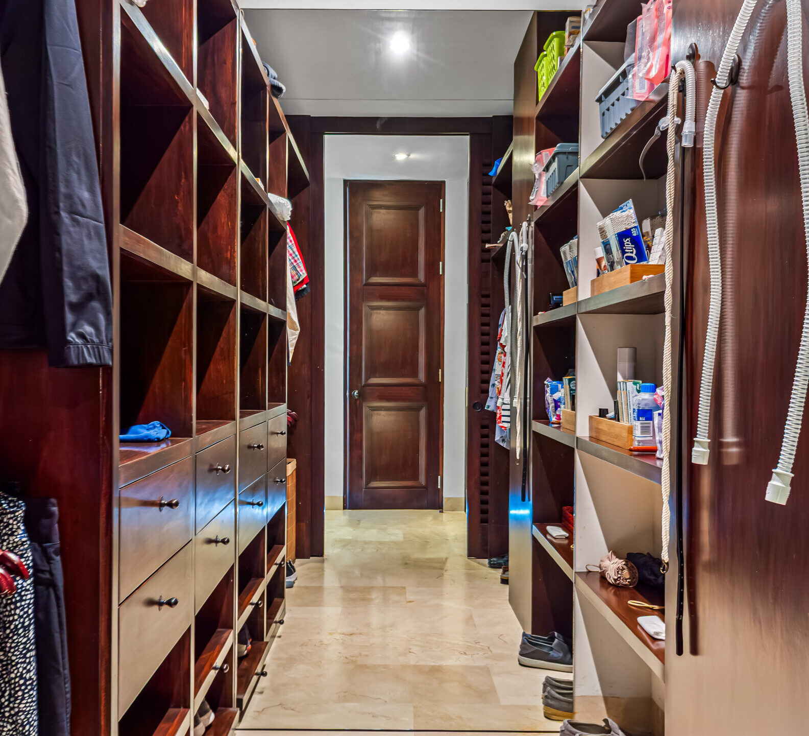 SDM Arco Major 4-25 Spacious walk-in closet with built-in shelving, hanging storage, and wood cabinetry.