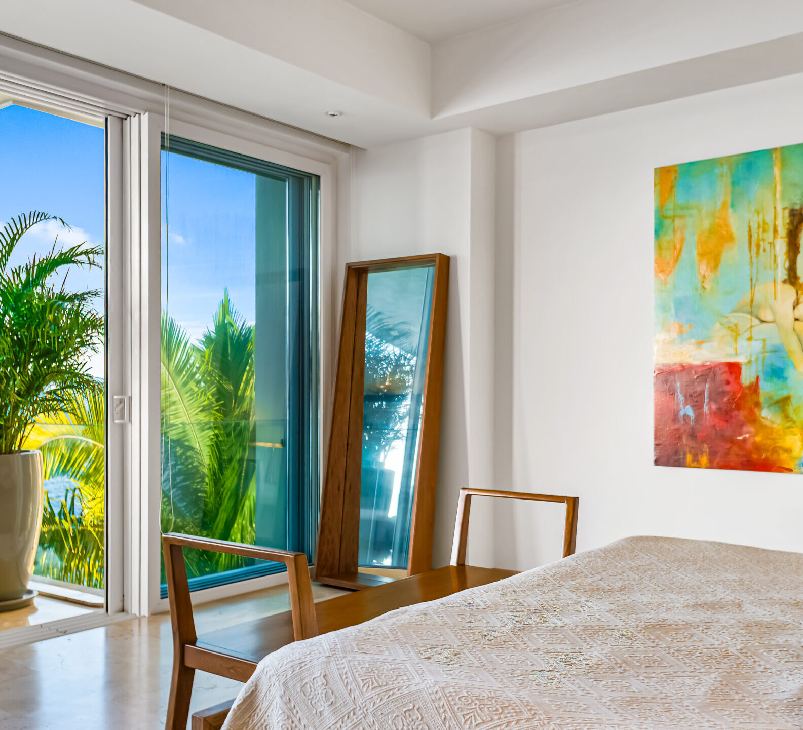 SDM Arco Major 4-27 Bright bedroom with colorful artwork and sliding glass doors opening to a private terrace. Walk-In Closet