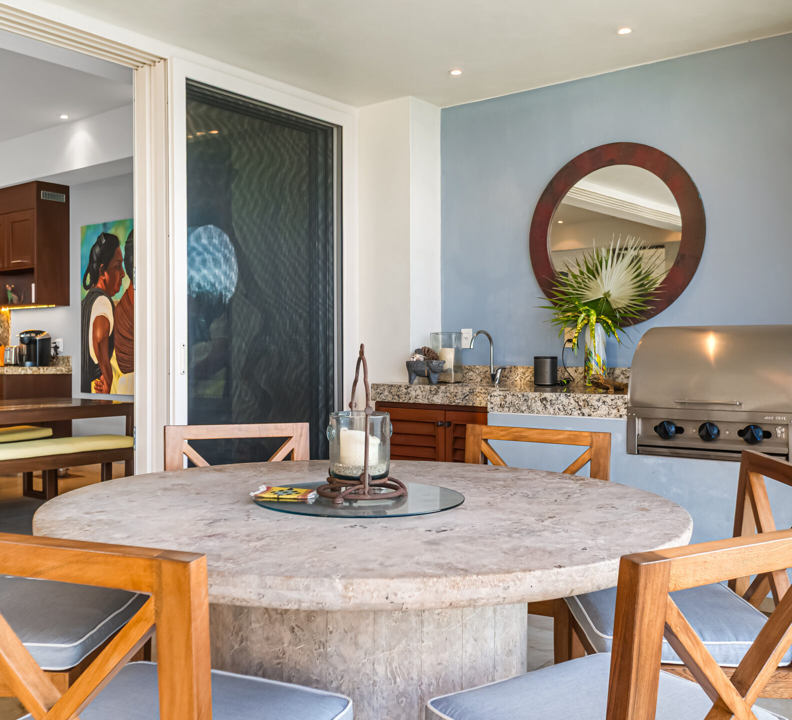 SDM Arco Major 4-32 Dining table beside an outdoor grill area connected to the interior living space. Covered Lounge Terrace
