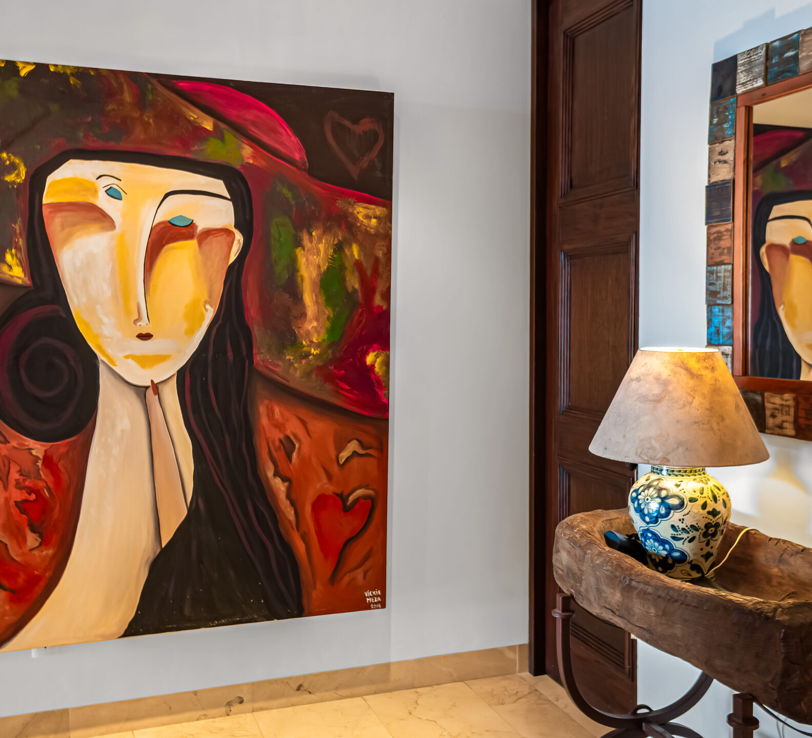SDM Arco Major 4-4 Abstract artwork displayed above a rustic console table with decorative lamp and mirror in a sophisticated entry hallway.