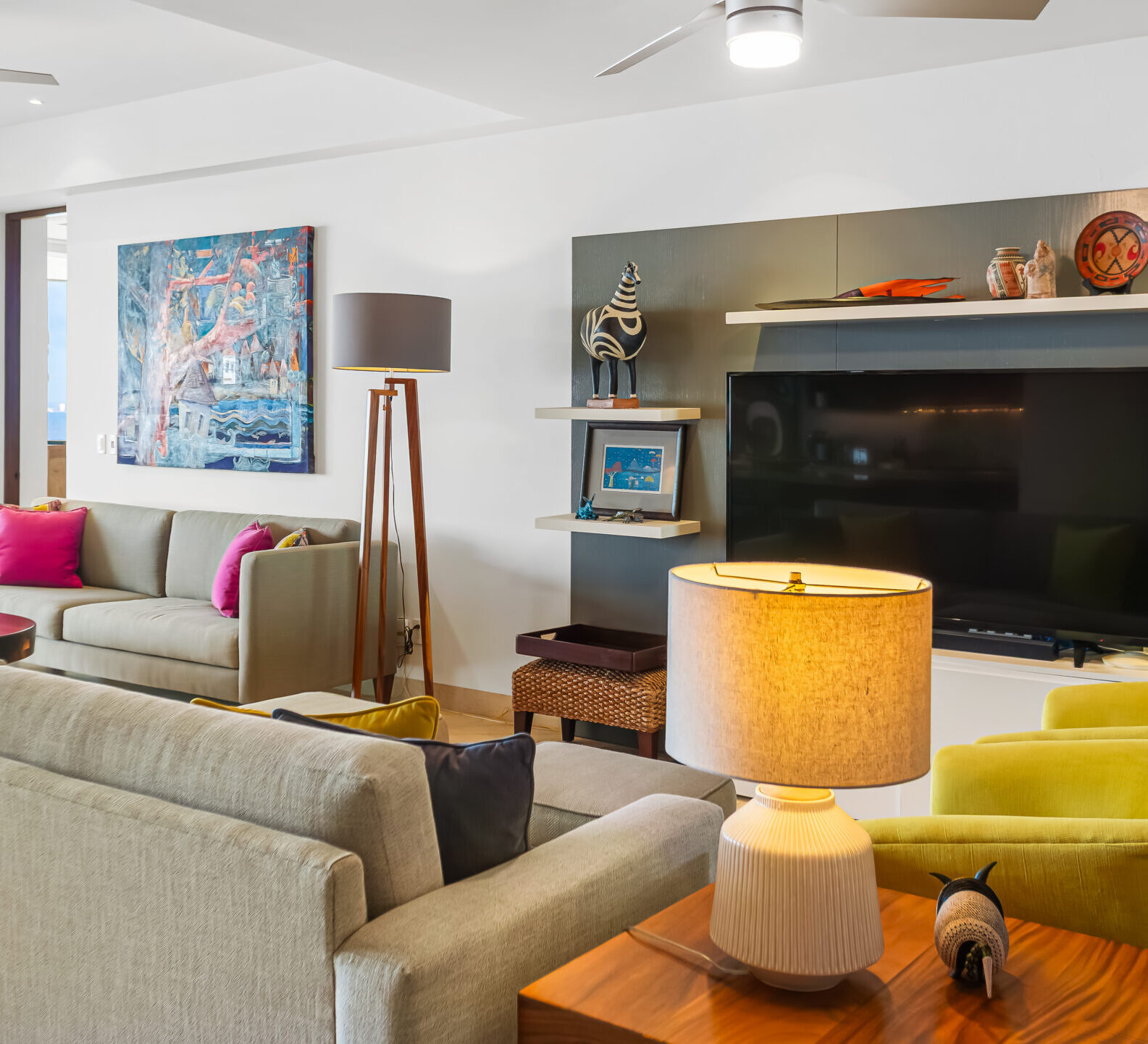 SDM Arco Major 4-5 Contemporary lounge area with plush seating, a fireplace, built-in shelving, and decorative lighting in an elegant coastal residence.