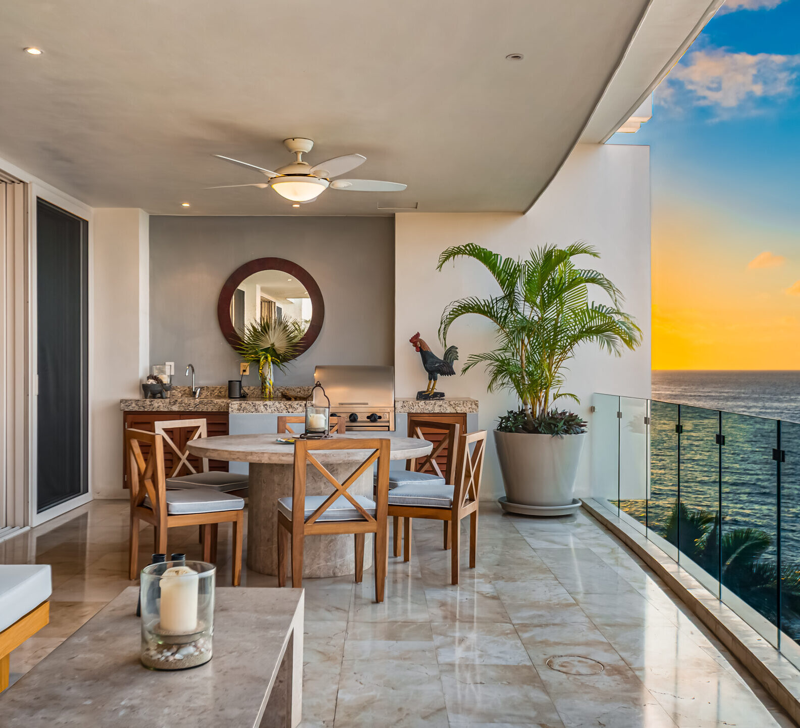 SDM Arco Major 4-51 Covered terrace with dining seating and panoramic views of the ocean at sunset.