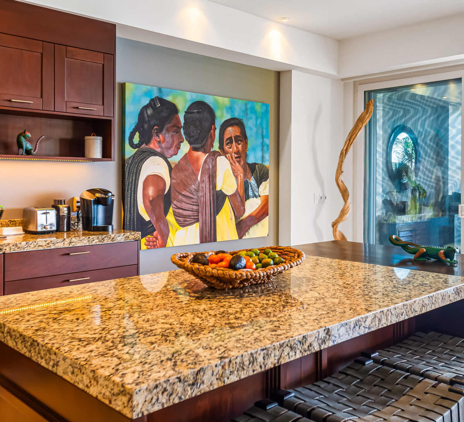 SDM Arco Major 4-8 Kitchen island with granite countertop, bar stools, and colorful artwork, set against an open-plan living area with ocean views.