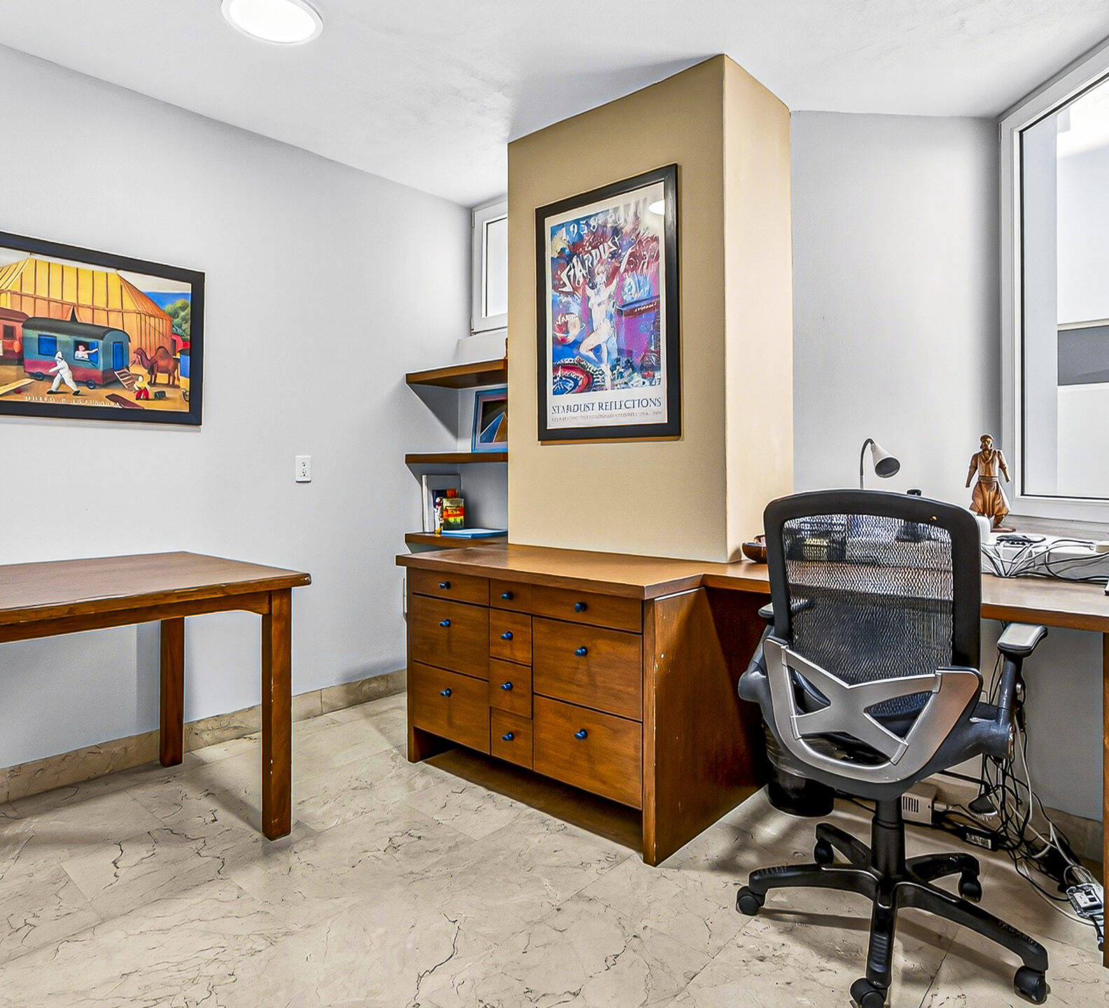 Home office with a desk, ergonomic chair, and built-in cabinetry.
