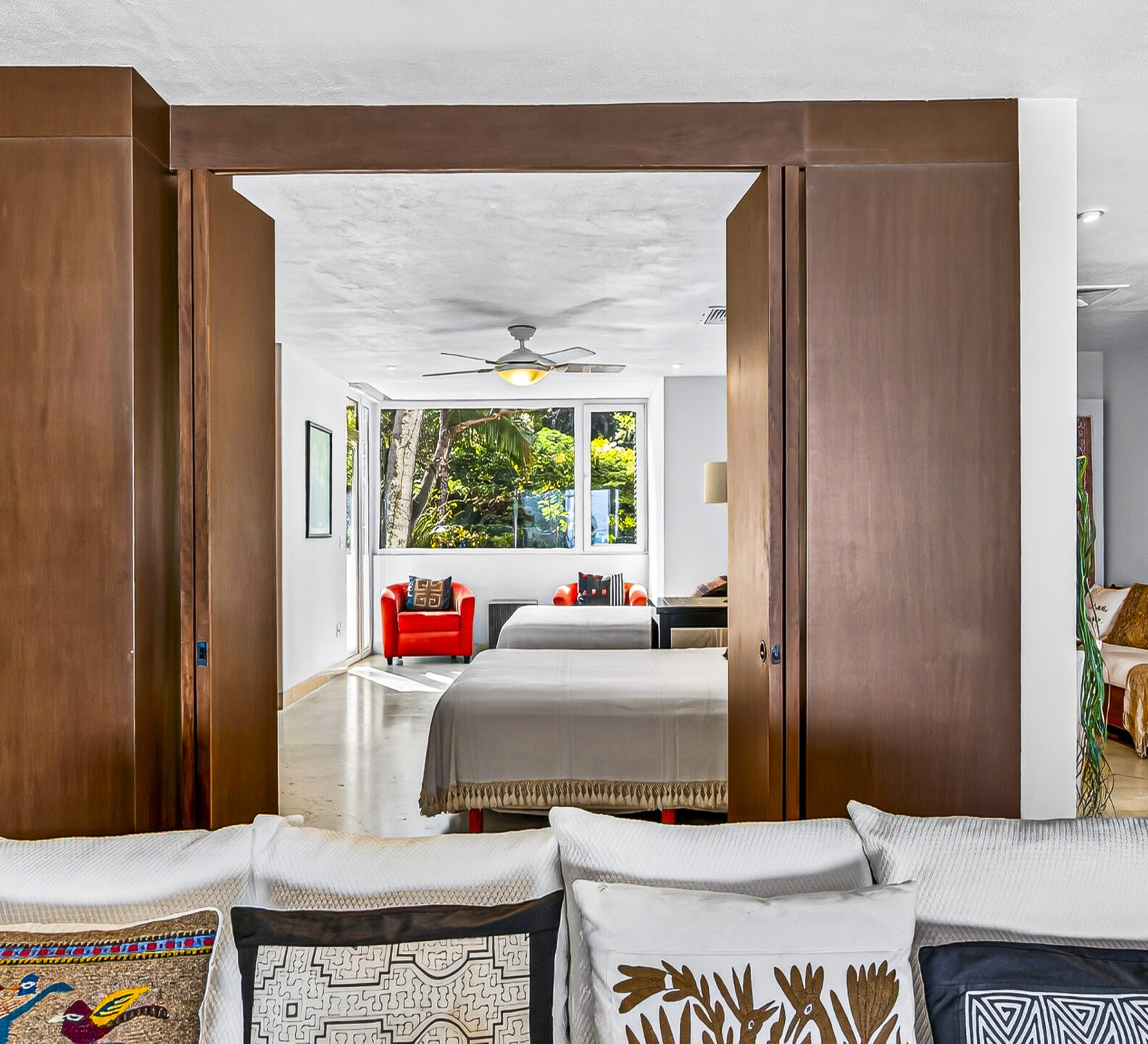 Comfortable sitting area with sliding wood doors opening to a bedroom.