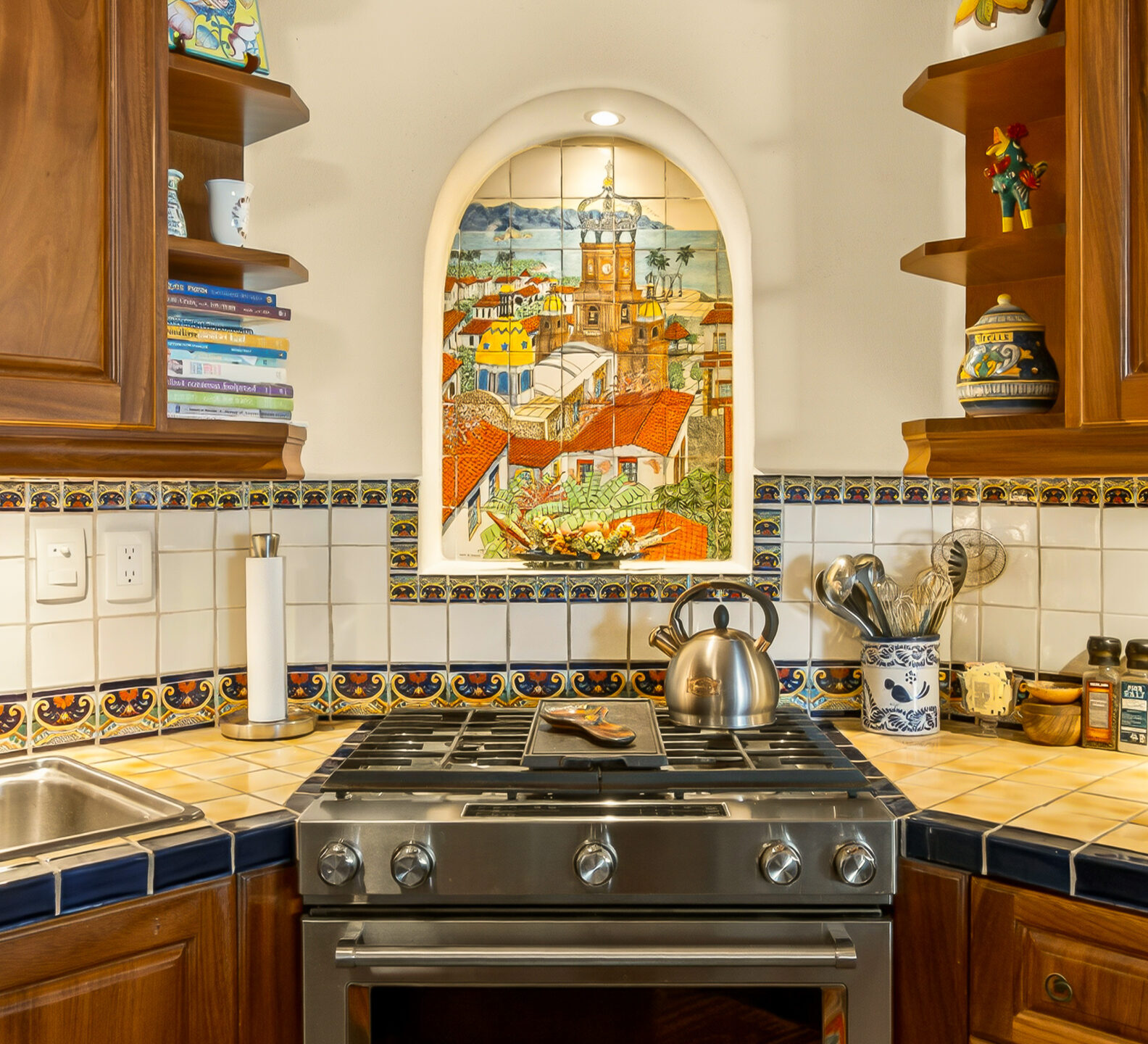Stove and backsplash area with wooden cabinets and an arched stained-glass window as the focal point.